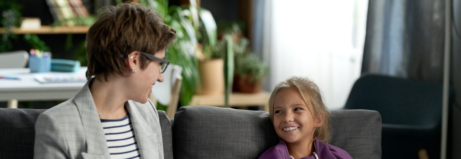 Social worker talking to child at home
